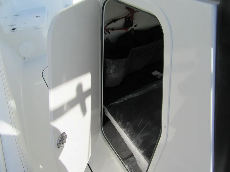 Slide: The Image of Open storage compartment on 2025 Parker 2400 Center Console boat. - 13