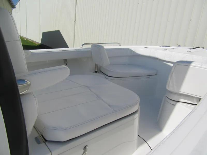 Slide: The Image of 2025 Parker 2400 Center Console boat interior with white cushioned seating. - 14
