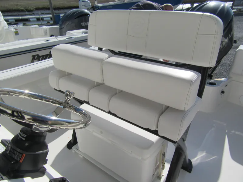 Slide: The Image of 2025 Parker 2400 Center Console boat with white cushioned seating and steering wheel. - 8