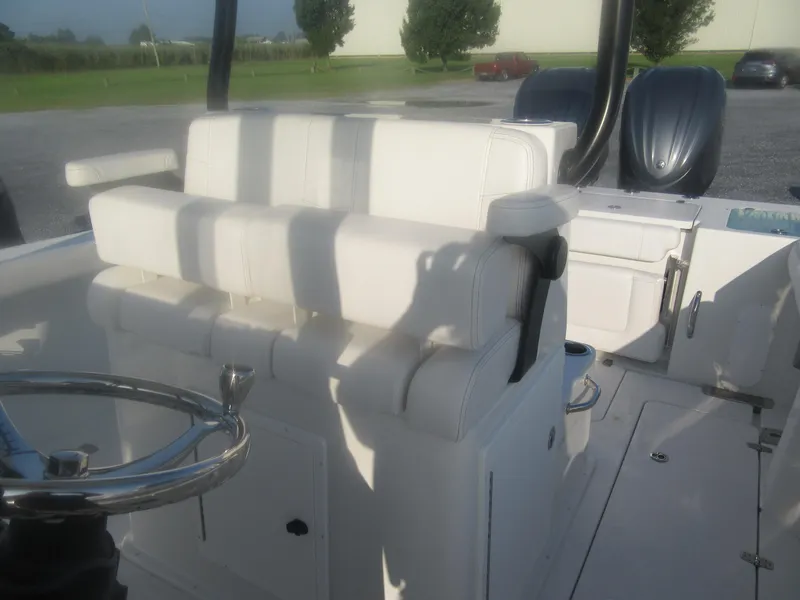 Slide: The Image of 2025 Parker 2900 Center Console boat interior with white seating and dual engines. - 10