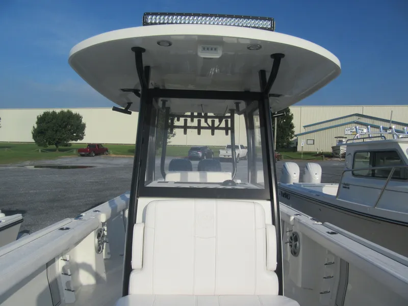 Slide: The Image of 2025 Parker 2900 Center Console boat with T-top and seating, docked outdoors. - 15