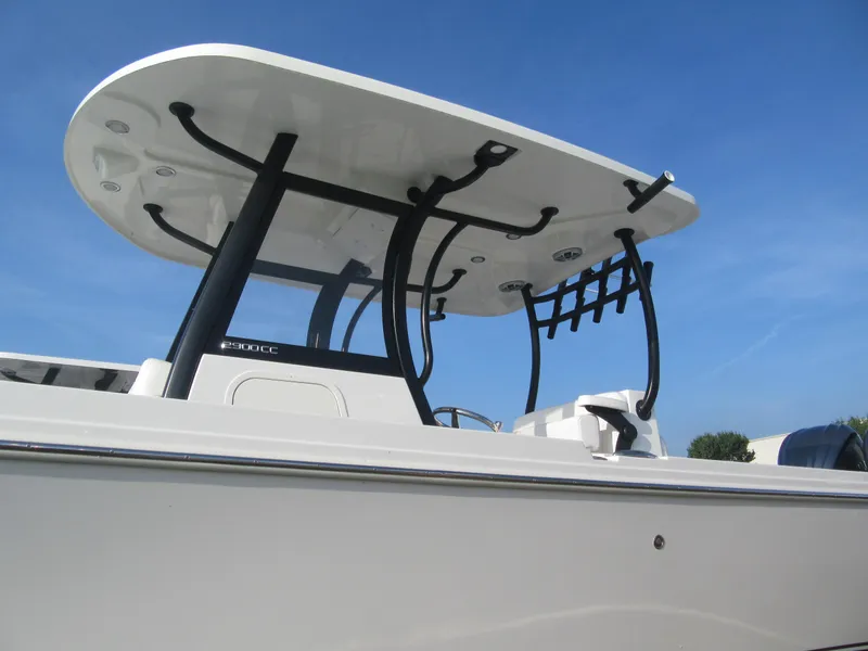 Slide: The Image of 2025 Parker 2900 Center Console boat with T-top against clear blue sky. - 25