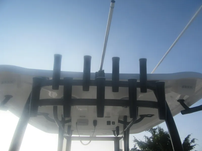 Slide: The Image of 2025 Parker 2900 Center Console boat with rod holders against a clear sky. - 7