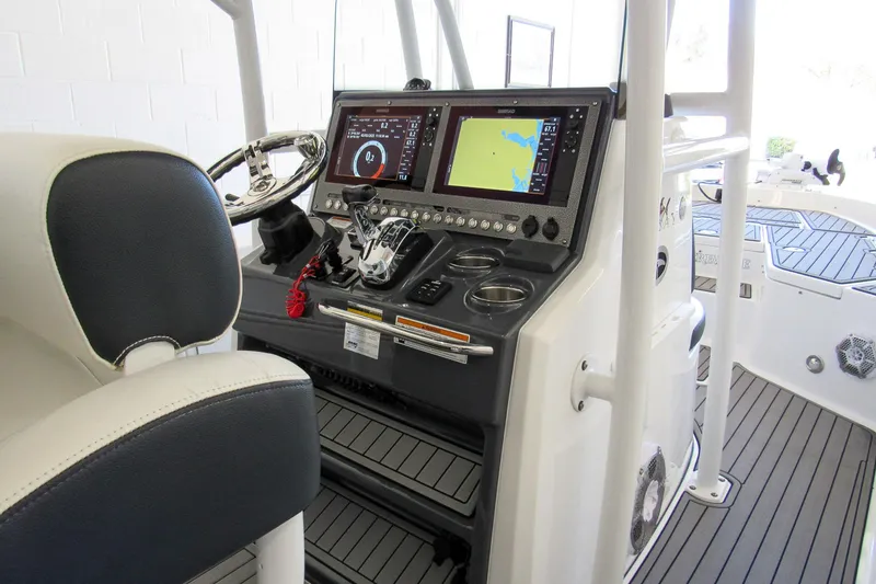 Slide: The Image of 2018 Crevalle 26 Bay boat dashboard with navigation screens and controls. - 29