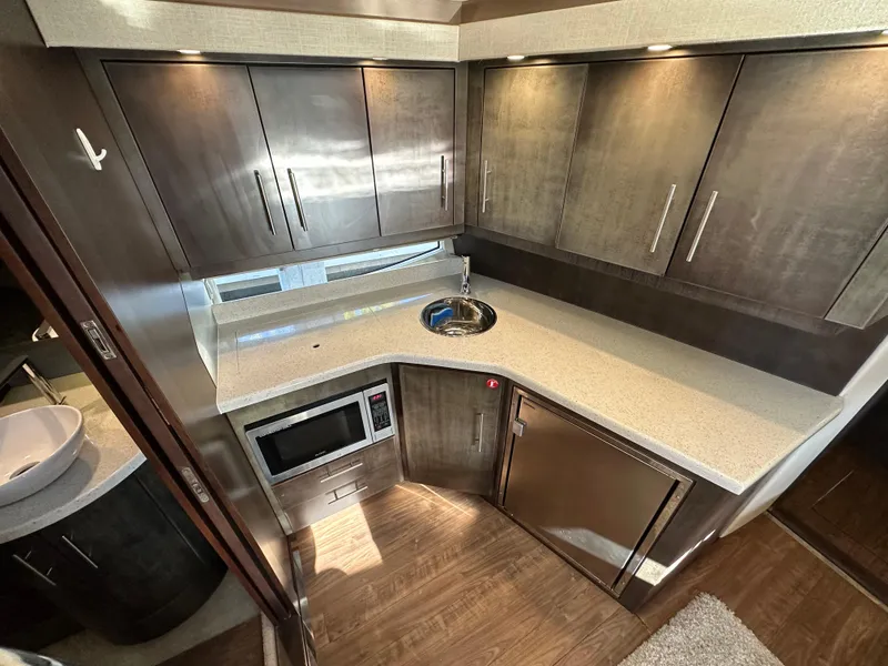 Slide: The Image of Modern kitchen interior of 2017 Regal 42 Sport Coupe yacht with sleek cabinetry and appliances. - 10