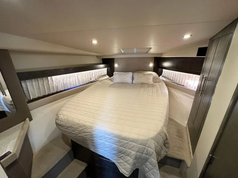 Slide: The Image of Luxurious bedroom interior of 2017 Regal 42 Sport Coupe yacht with cozy bedding. - 11