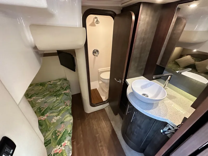 Slide: The Image of 2017 Regal 42 Sport Coupe interior with bed, bathroom, and modern sink area. - 12