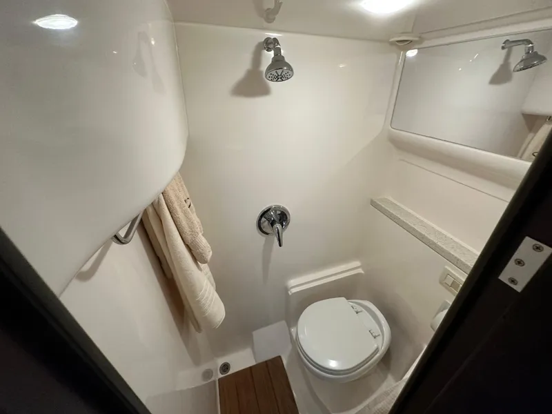 Slide: The Image of Bathroom interior of 2017 Regal 42 Sport Coupe yacht, featuring shower and toilet. - 13
