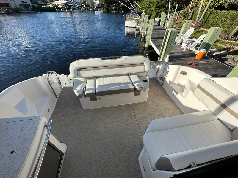 Slide: The Image of 2017 Regal 42 Sport Coupe boat interior with spacious seating by the water. - 15