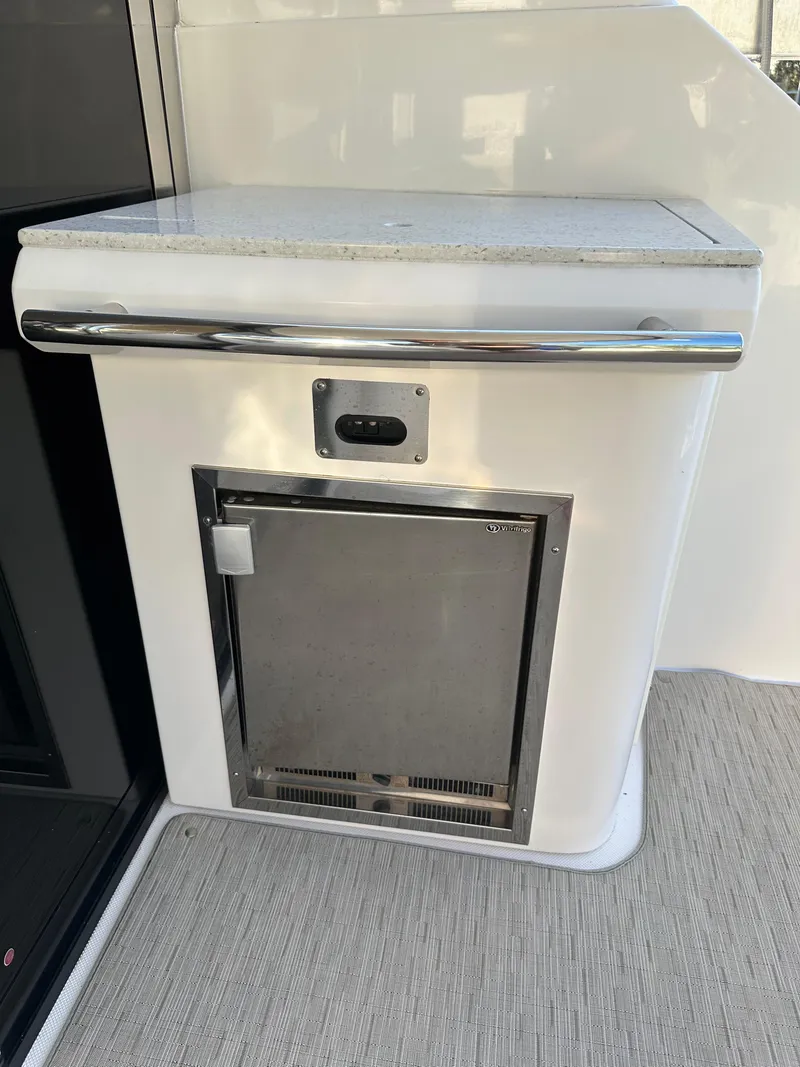 Slide: The Image of 2017 Regal 42 Sport Coupe interior with stainless steel mini-fridge and countertop. - 17