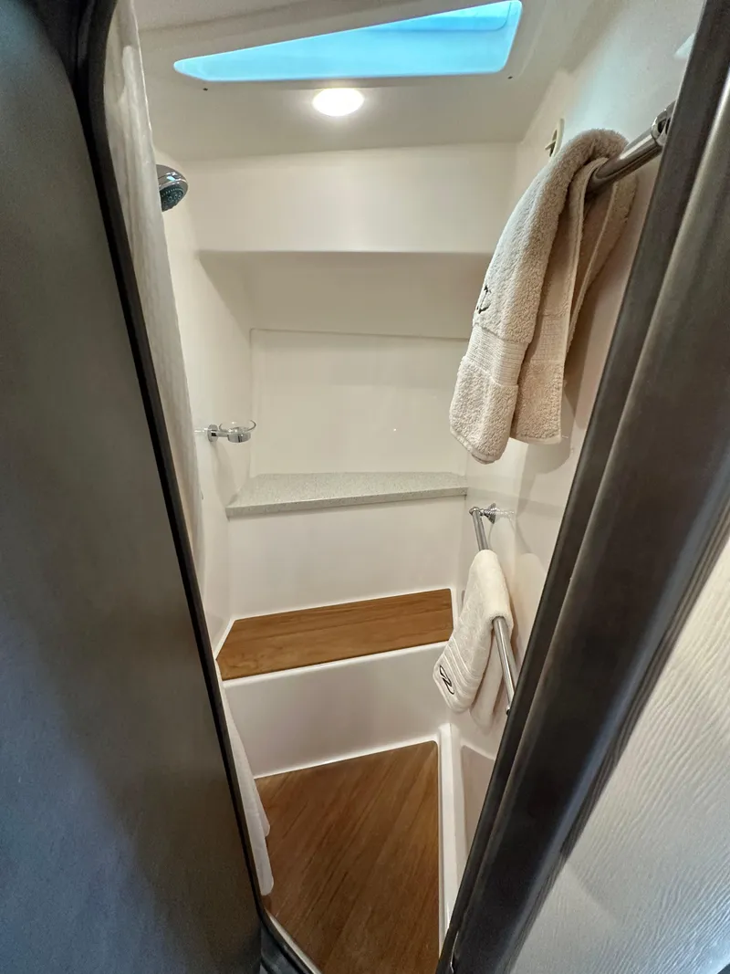 Slide: The Image of 2017 Regal 42 Sport Coupe bathroom with wooden flooring and towels. - 7