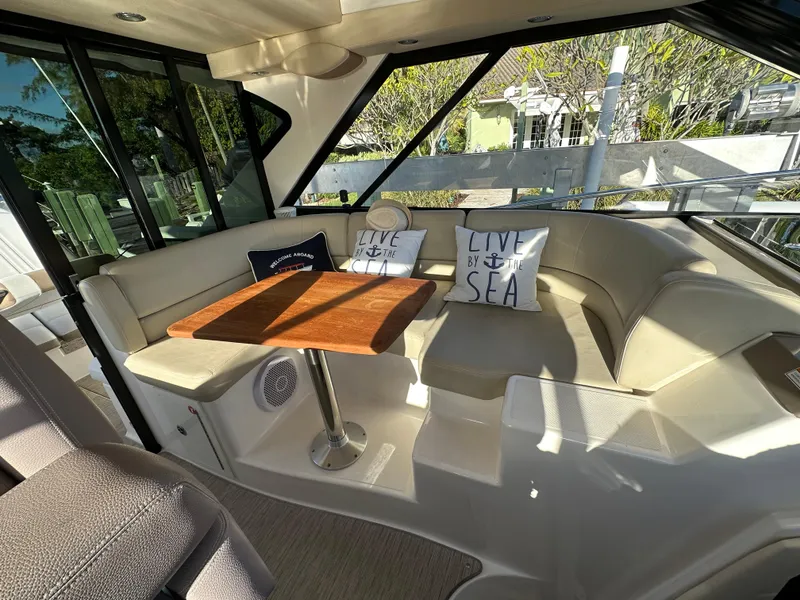 Slide: The Image of 2017 Regal 42 Sport Coupe interior with cushioned seating and decorative pillows. - 9