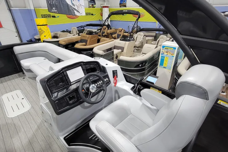 Slide: The Image of 2022 Bentley Pontoons Elite 253 Swingback interior with modern helm and seating. - 11