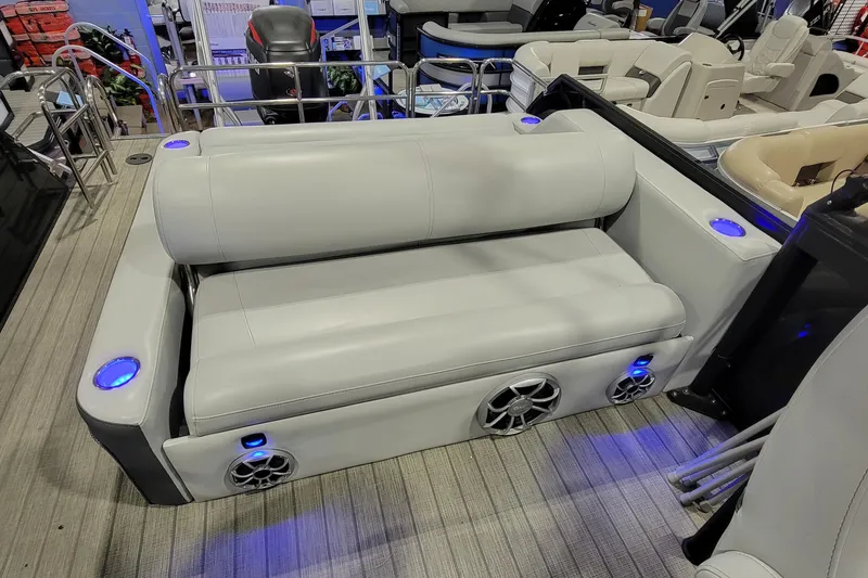 Slide: The Image of 2022 Bentley Pontoons Elite 253 Swingback interior with plush seating and integrated speakers. - 5