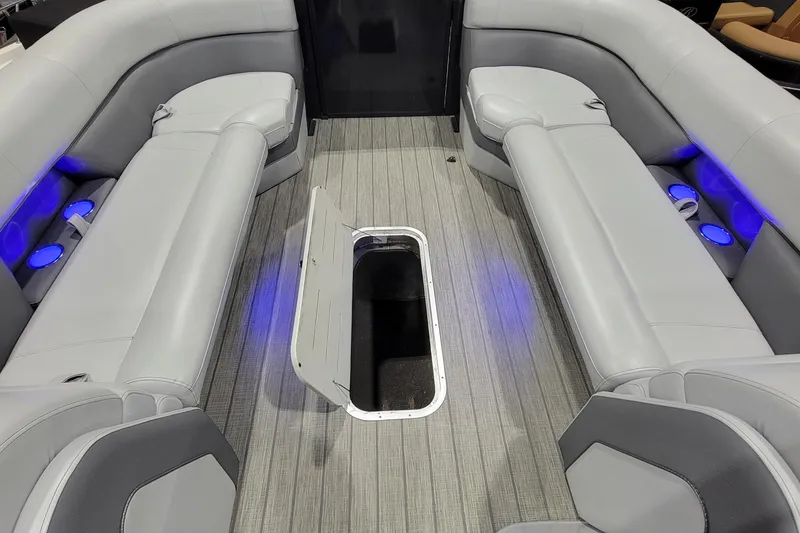 Slide: The Image of 2022 Bentley Pontoons Elite 253 Swingback interior with gray seating and blue LED lighting. - 6