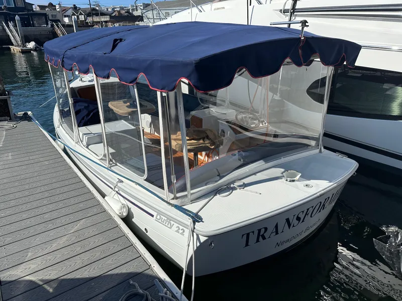 Slide: The Image of 2021 Duffy Bay Island boat docked with blue canopy in Newport Beach marina. - 0