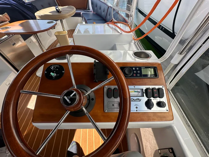 Slide: The Image of Steering wheel and control panel of a 2021 Duffy Bay Island boat interior. - 3