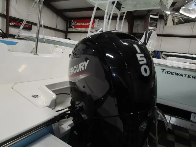 Slide: The Image of 2023 Bayliner 210EL with Mercury 150 outboard engine in showroom. - 13