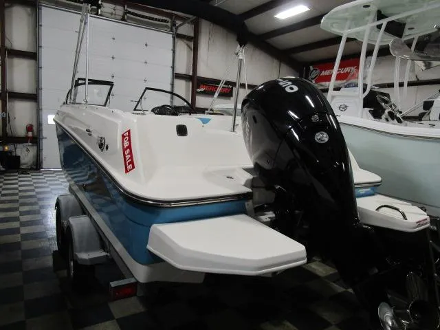 Slide: The Image of 2023 Bayliner 210EL boat for sale in showroom, featuring sleek design and powerful engine. - 4