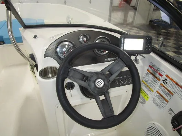 Slide: The Image of Dashboard of 2023 Bayliner 210EL boat with steering wheel and navigation system. - 6