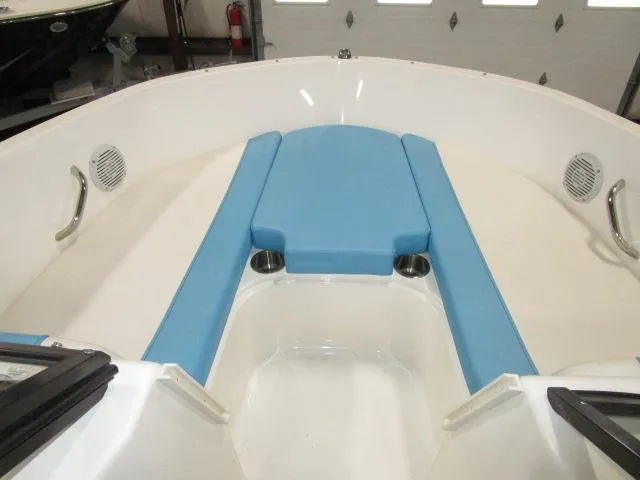 Slide: The Image of 2023 Bayliner 210EL boat interior with blue seating and cup holders. - 7