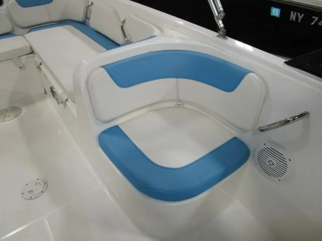 Slide: The Image of 2023 Bayliner 210EL boat interior with blue and white seating. - 8