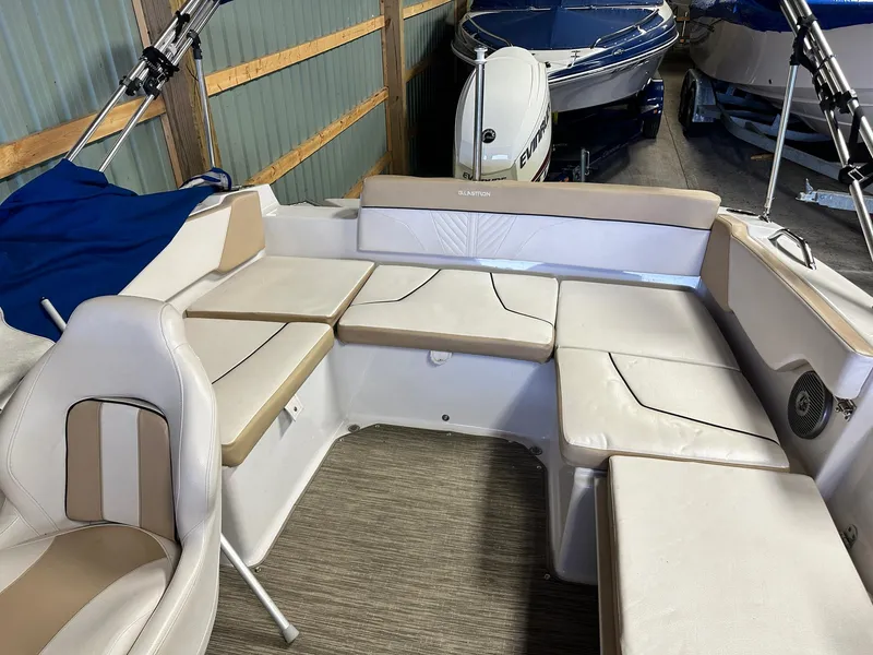 Slide: The Image of 2019 Glastron GTD 180 boat interior with beige seating and storage compartments. - 10