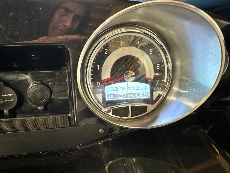 Slide: The Image of 2019 Glastron GTD 180 dashboard with temperature and water hours display. - 4