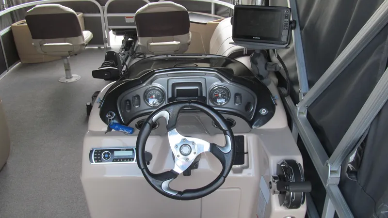 Slide: The Image of 2018 Sun Tracker Fishin' Barge 22 XP3 dashboard with steering wheel and controls. - 10