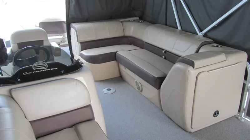 Slide: The Image of 2018 Sun Tracker Fishin' Barge 22 XP3 interior with beige seating and steering console. - 15