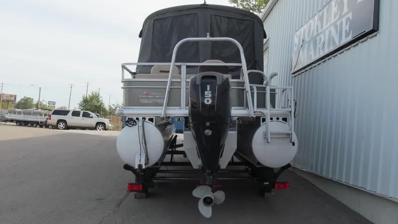 Slide: The Image of 2018 Sun Tracker Fishin' Barge 22 XP3 pontoon boat, rear view with motor, parked at marina. - 3