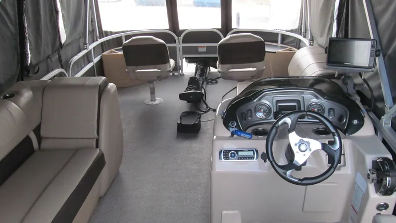 Slide: The Image of Interior of 2018 Sun Tracker Fishin' Barge 22 XP3, featuring seating and control console. - 9