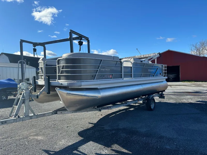 The Image of 2023 Godfrey SWEETWATER 2286 SFL pontoon boat on trailer, parked outdoors. - 0