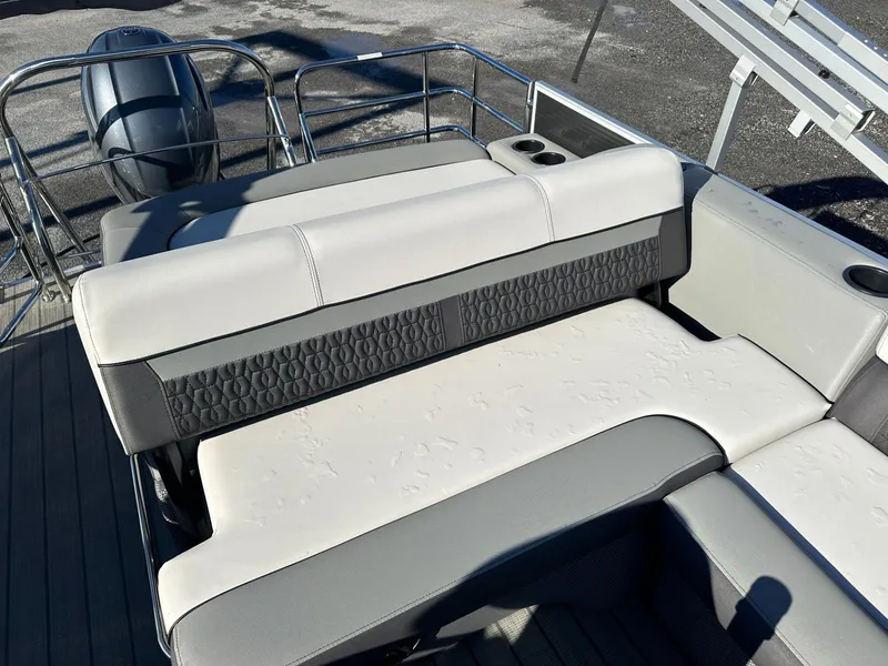 Slide: The Image of 2023 Godfrey SWEETWATER 2286 SFL boat interior with cushioned seating and cup holders. - 5