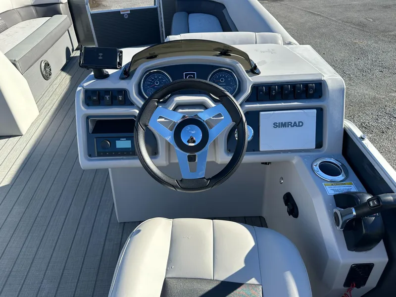 Slide: The Image of 2023 Godfrey SWEETWATER 2286 SFL boat dashboard with steering wheel and Simrad display. - 8