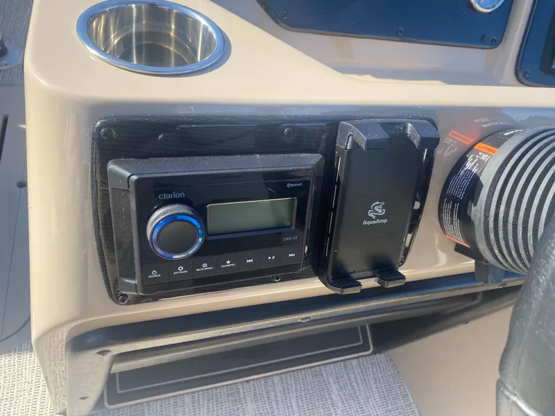Slide: The Image of Dashboard of 2025 SunCatcher Select 322RC with stereo system and cup holder. - 10