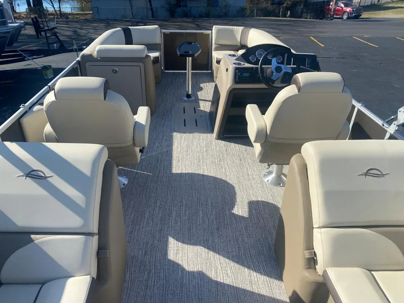Slide: The Image of 2025 SunCatcher Select 322RC pontoon boat interior with beige seating and modern dashboard. - 13
