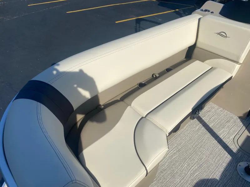 Slide: The Image of 2025 SunCatcher Select 322RC boat interior with beige seating and carpeted flooring. - 14