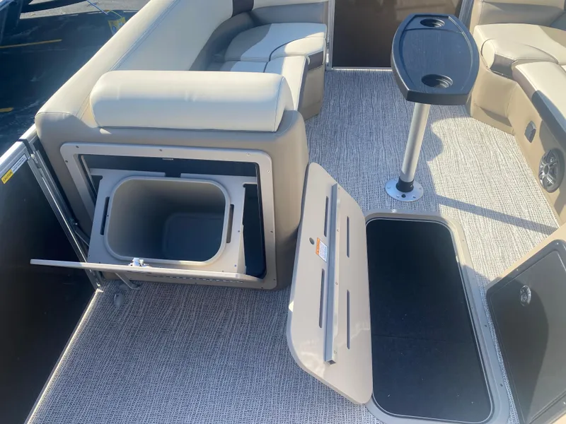 Slide: The Image of 2025 SunCatcher Select 322RC boat interior with seating, storage, and table. - 18