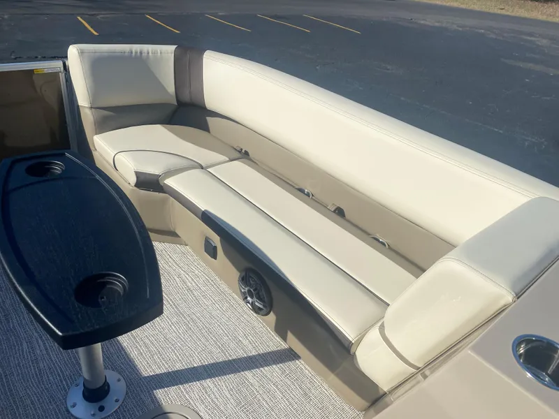 Slide: The Image of Luxurious seating on 2025 SunCatcher Select 322RC pontoon boat with table and cup holders. - 21