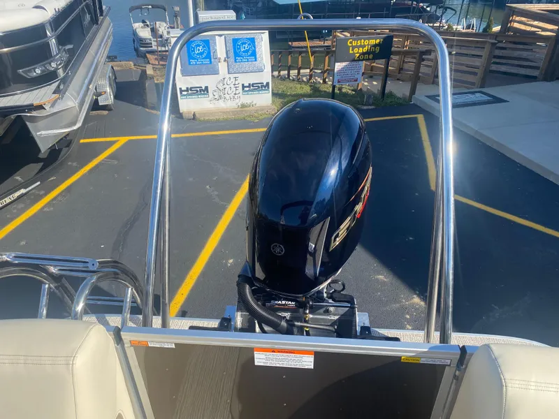 Slide: The Image of 2025 SunCatcher Select 322RC boat with Yamaha outboard motor at marina loading zone. - 5