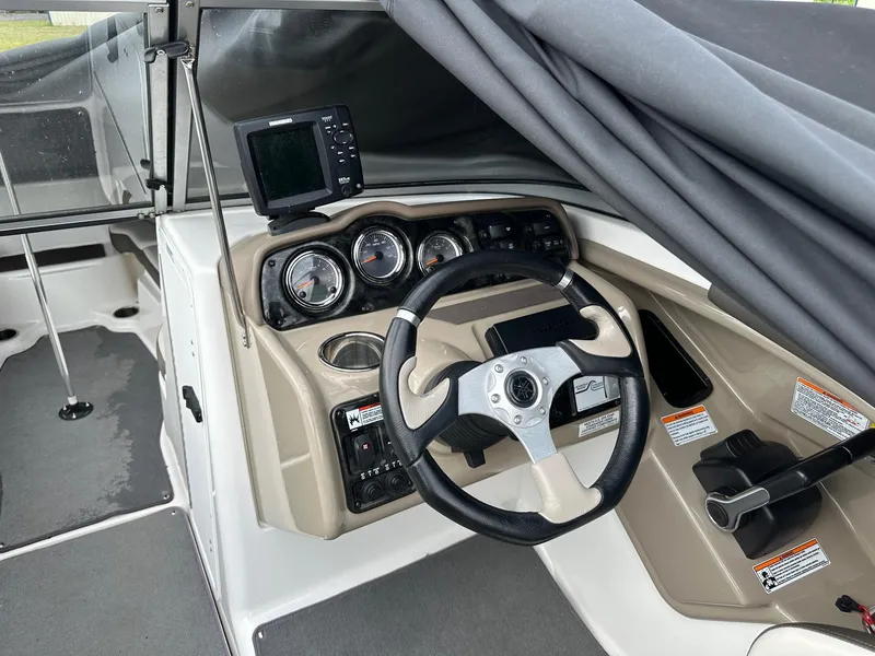 Slide: The Image of 2012 Yamaha Boats 242 Limited S dashboard with steering wheel and controls. - 16