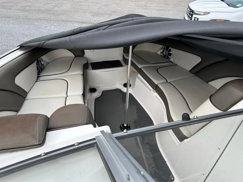 Slide: The Image of 2012 Yamaha Boats 242 Limited S interior with cushioned seating and cover. - 17