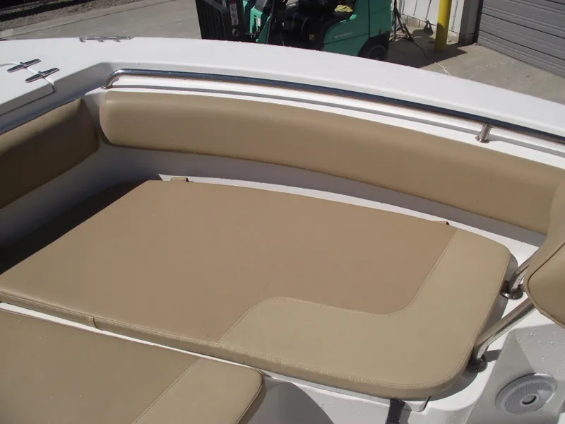Slide: The Image of 2012 Sea Hunt Ultra 211 boat with beige cushioned seating in the bow area. - 10