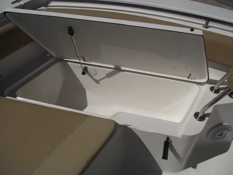 Slide: The Image of Open storage compartment on 2012 Sea Hunt Ultra 211 boat. - 12