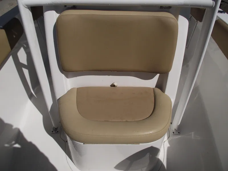 Slide: The Image of 2012 Sea Hunt Ultra 211 boat seat with beige cushions. - 13