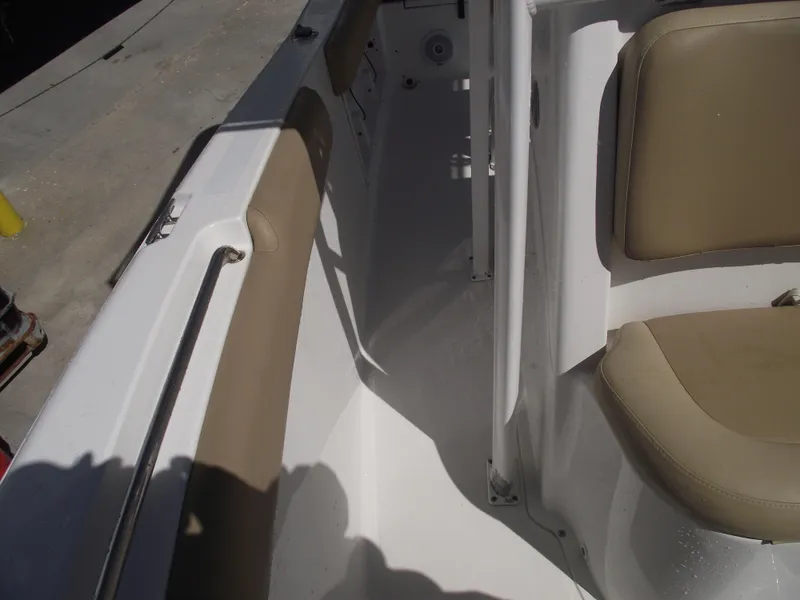 Slide: The Image of 2012 Sea Hunt Ultra 211 boat interior with beige seating and white deck. - 16