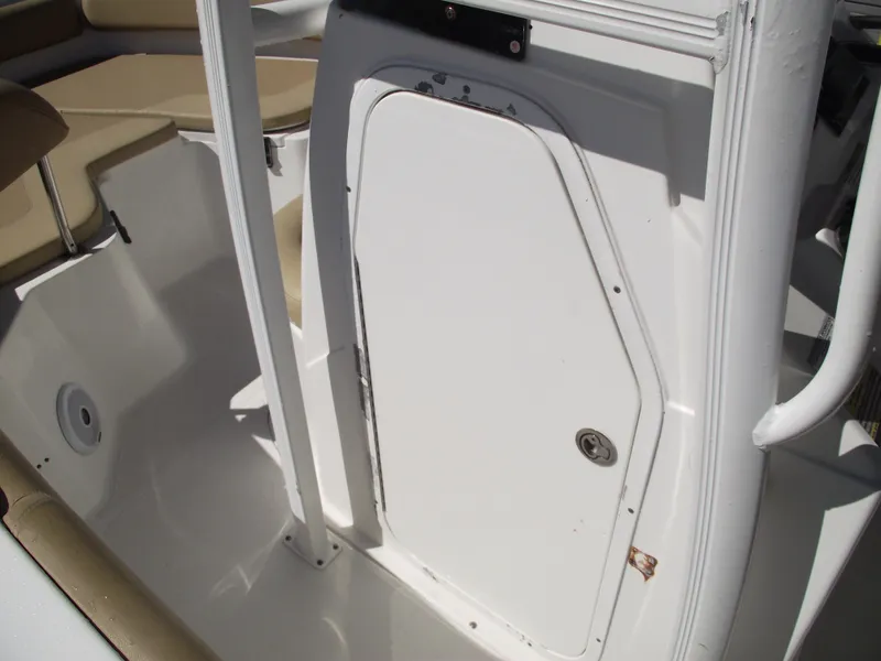 Slide: The Image of Sea Hunt Ultra 211 boat interior, 2012 model, featuring a white storage compartment door. - 18