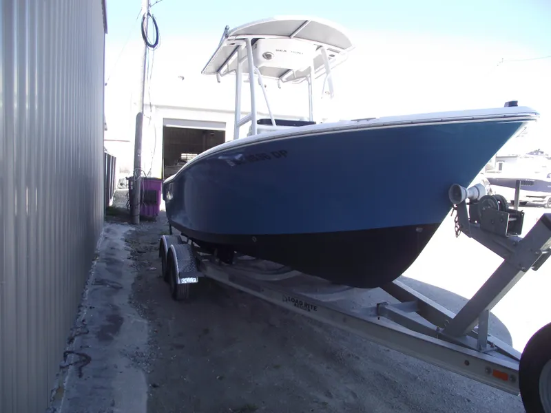 Slide: The Image of 2012 Sea Hunt Ultra 211 boat on trailer, parked outdoors. - 2