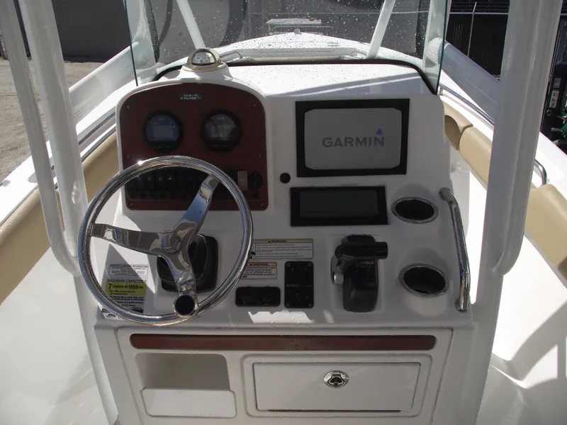 Slide: The Image of 2012 Sea Hunt Ultra 211 boat dashboard with Garmin navigation system and steering wheel. - 21